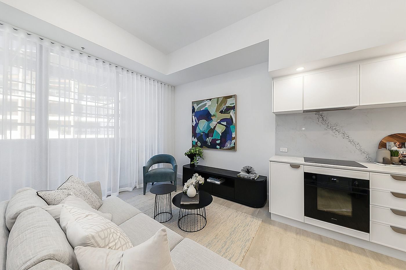 Living area and kitchen in a display apartment at The Grande